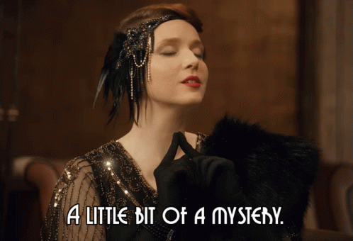 A Woman With Her Eyes Closed And The Words A Little Bit Of A Mystery GIF
