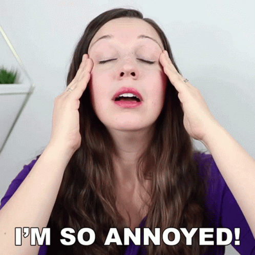 A Woman With Her Eyes Closed Has Her Hands On Her Head And The Words I 'M So Annoyed Below Her GIF