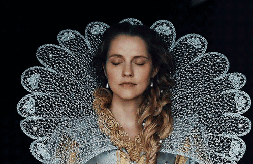 A Woman With Her Eyes Closed Is Wearing A Lace Collar Around Her Neck GIF