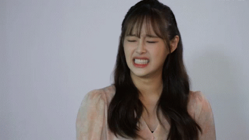 A Woman With Her Eyes Closed Making A Funny Face GIF