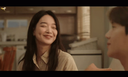A Woman With Her Eyes Closed Smiles Next To A Man With His Eyes Closed GIF