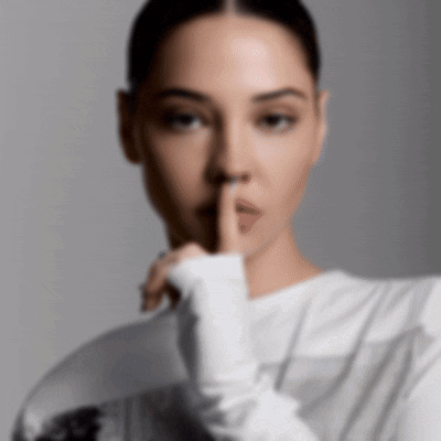 A Woman With Her Finger To Her Mouth GIF