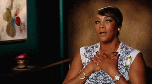 A Woman With Her Hands On Her Chest Is Wearing A Watch And Bracelets . GIF