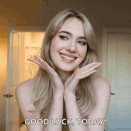 A Woman With Her Hands On Her Face Is Smiling And Says " Good Luck Today " GIF