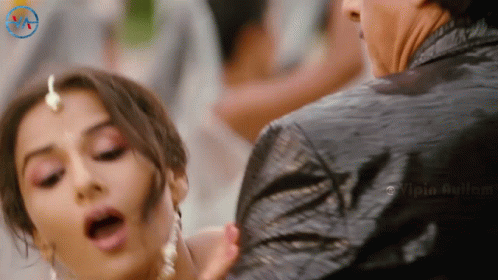 A Woman With Her Mouth Open Is Being Held By A Man In A Black Jacket With A Watermark That Says Vipia Aulum GIF