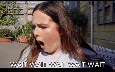 A Woman With Her Mouth Wide Open And The Words Wait Wait Wait Wait GIF