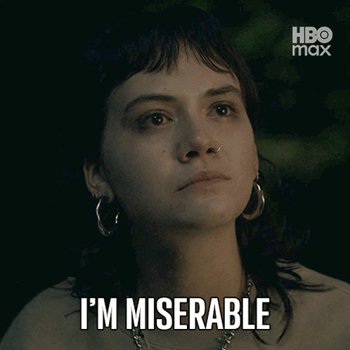 A Woman With Hoop Earrings Says I 'M Miserable In Front Of A Hbo Max Logo GIF