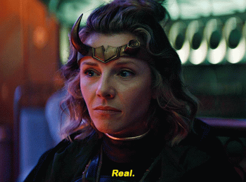 A Woman With Horns On Her Head Is Wearing A Black Shirt With The Word Real On It GIF