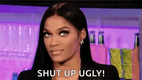 A Woman With Long Black Hair Is Making A Funny Face And Says `` Shut Up Ugly '' . GIF
