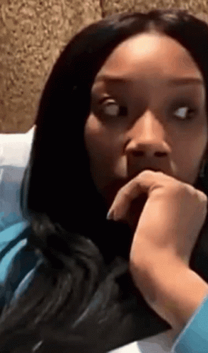Woman With Long Black Hair Sitting On Bed GIF