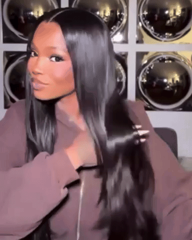 A Woman With Long Black Hair Is Standing In Front Of A Laundry Room . GIF