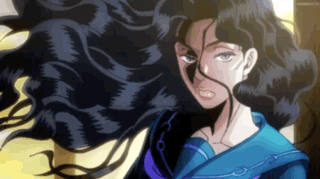 A Woman With Long Black Hair Is Wearing A Blue Shirt And A Purple Necklace . GIF