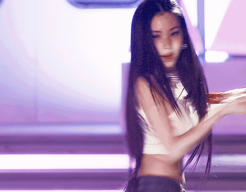 A Woman With Long Black Hair Is Wearing A Crop Top GIF