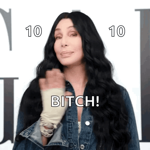 A Woman With Long Black Hair Is Wearing A Denim Jacket And Says Bitch ! GIF