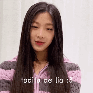A Woman With Long Black Hair Is Wearing A Pink And Gray Striped Sweater And Says Todita De Lia : 3 . GIF