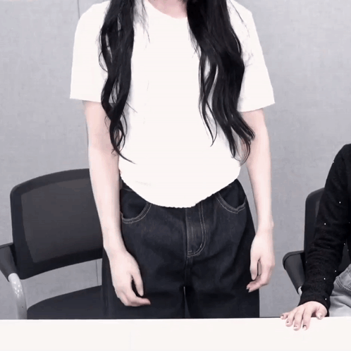 A Woman With Long Black Hair Is Wearing A White Shirt GIF
