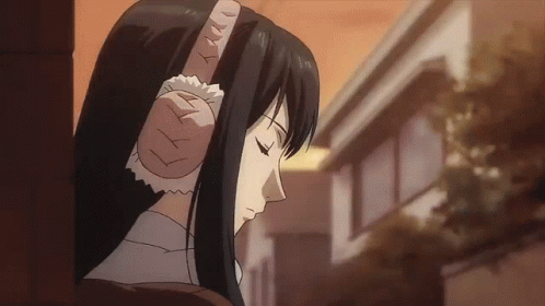 A Woman With Long Black Hair Is Wearing Ear Protectors GIF