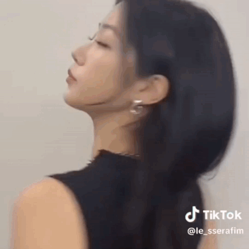 Woman With Long Black Hair Wearing Earrings And Necklace GIF