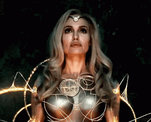 A Woman With Long Blonde Hair And A Crown On Her Head GIF