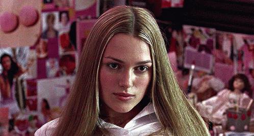 A Woman With Long Blonde Hair And A White Shirt GIF