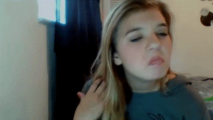 A Woman With Long Blonde Hair Is Making A Funny Face With Her Hand On Her Shoulder GIF