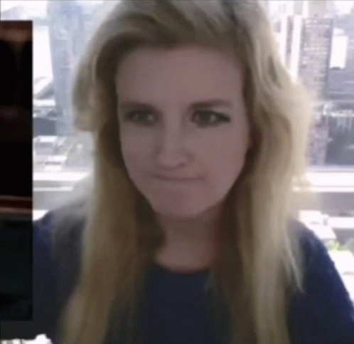 A Woman With Long Blonde Hair Is Making A Funny Face GIF