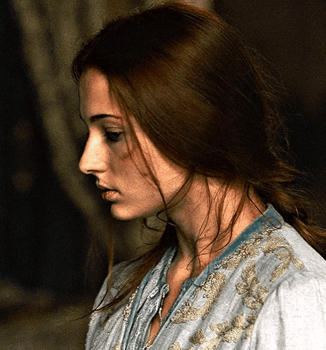 A Woman With Long Brown Hair Is Wearing A Blue Shirt GIF