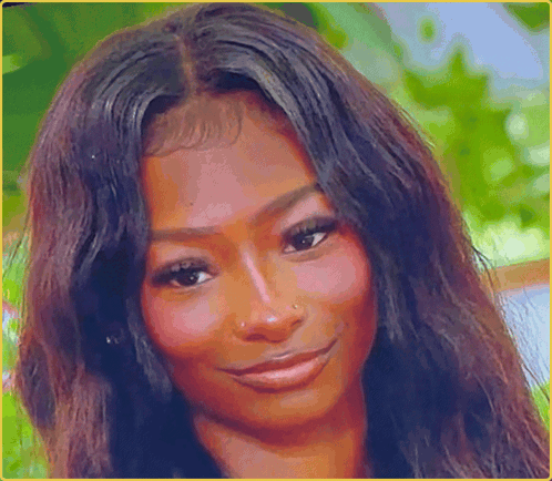 A Woman With Long Dark Hair Is Smiling For The Camera GIF