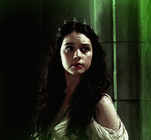 A Woman With Long Dark Hair Wearing A Tiara On Her Head GIF