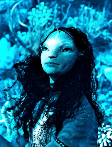 A Woman With Long Hair And A Blue Face Is Looking Up At The Sky GIF