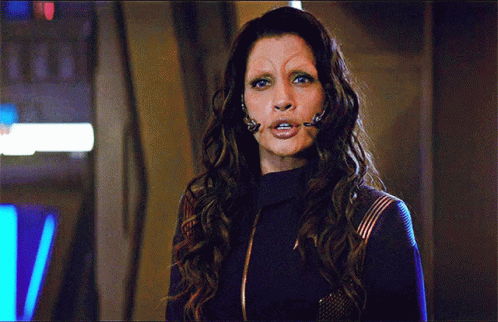 A Woman With Long Hair And A Fake Eyebrow GIF