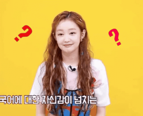 A Woman With Long Hair And A Microphone Is Surrounded By Question Marks And A Foreign Language . GIF
