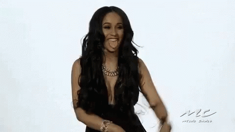 A Woman With Long Hair And A Necklace Is Smiling And Dancing . GIF