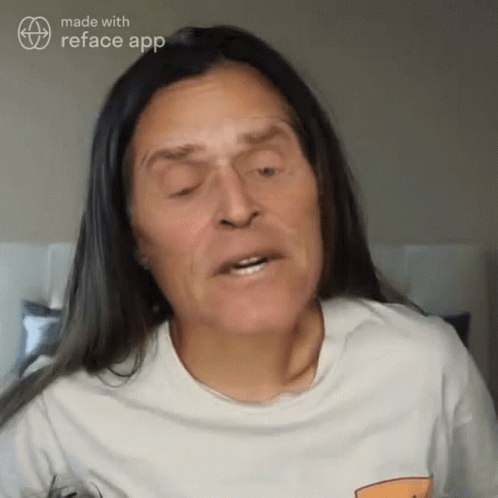 A Woman With Long Hair And A White Shirt Is Made With Reface App GIF