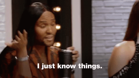 A Woman With Long Hair Is Holding A Cup And Saying I Just Know Things . GIF