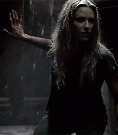 A Woman With Long Hair Is Holding A Knife In Her Hand . GIF