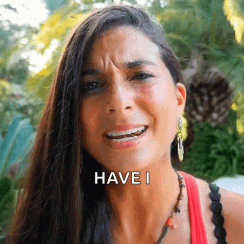 A Woman With Long Hair Is Making A Funny Face And The Words Have I Are On Her Face GIF