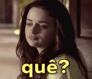 A Woman With Long Hair Is Making A Funny Face With The Words Que ? Written On Her Face . GIF
