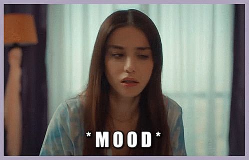 A Woman With Long Hair Is Sitting In Front Of A Window With The Words * Mood * Written On The Bottom GIF