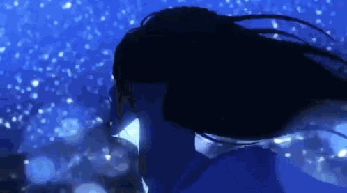 A Woman With Long Hair Is Swimming In The Water At Night . GIF