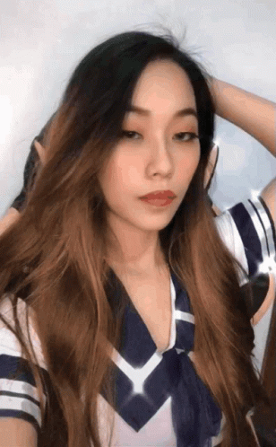 A Woman With Long Hair Is Wearing A Blue And White Sailor Outfit GIF