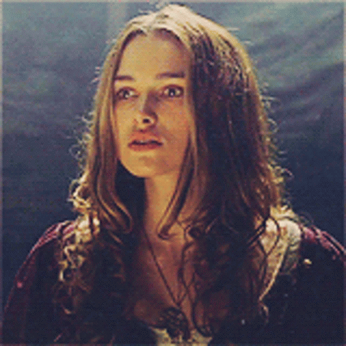 A Woman With Long Hair Is Wearing A Necklace And A Red Shirt GIF