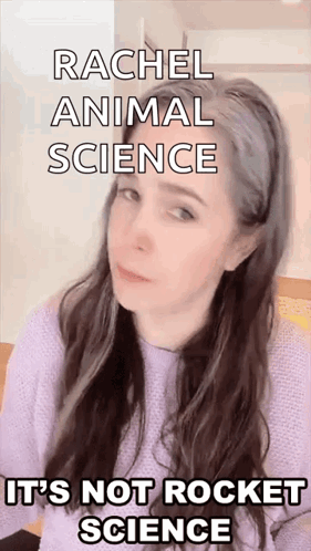A Woman With Long Hair Is Wearing A Purple Sweater And Making A Funny Face While Talking About Animal Science GIF
