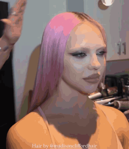 a woman with long pink hair is getting her hair done by madisoncliffordhair