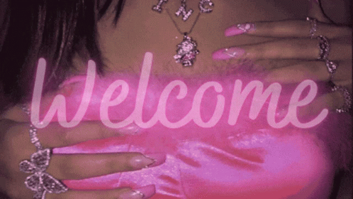A Woman With Long Pink Nails Is Wearing A Necklace And Rings And The Words Welcome Are Displayed GIF