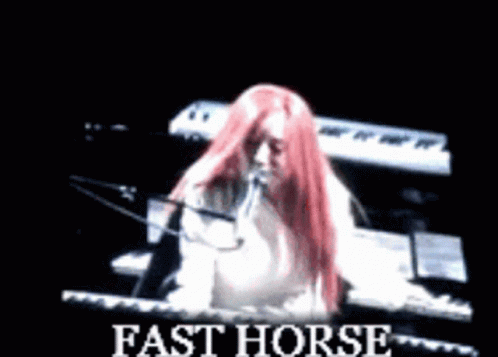 Woman With Red Hair Playing Piano And Singing Fast Horse GIF