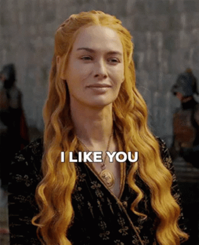 A Woman With Long Red Hair Is Smiling And Says " I Like You " GIF
