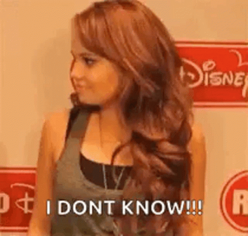 A Woman With Long Red Hair Is Standing In Front Of A Disney Logo And Says `` I Dont Know '' . GIF