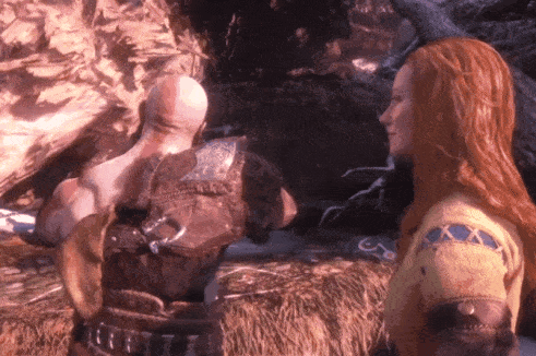 A Woman With Long Red Hair Is Standing Next To A Man GIF
