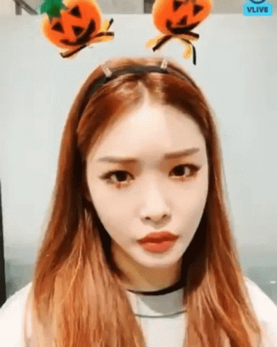 A Woman With Long Red Hair Wearing A Headband With Pumpkins On It . GIF